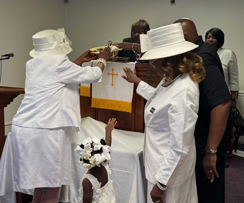 Faith Cathedral church family gathered at the altar